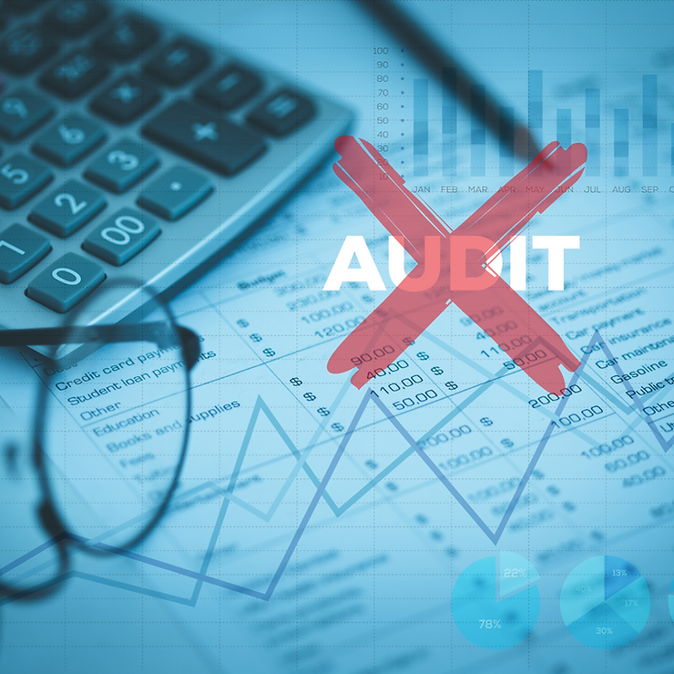 Financial documents with charts, a calculator, and glasses, overlaid by a red "audit" stamp, emphasizing the concept of financial examination.