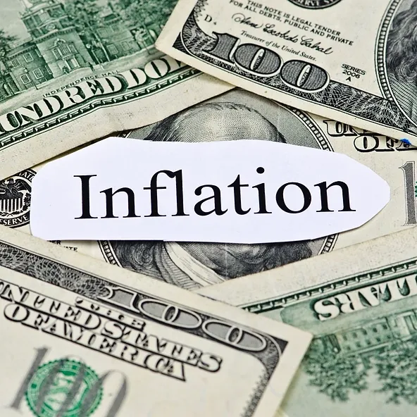 A label with the word "inflation" placed over assorted u.s. dollar bills.