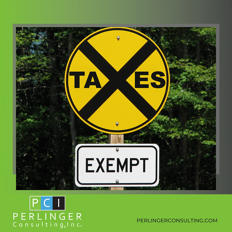 A yellow road sign with a black cross and the word "taxes" in the center, with an additional sign below it reading "exempt." the sign is surrounded by green foliage.