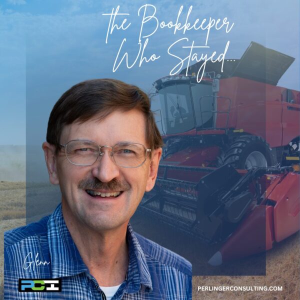 Glenn Perlinger, small business bookkeeper in Colorado, standing in front of a tractor on the farm. The Bookkeeper Who Stayed.